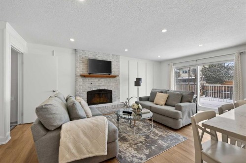 60 Sunmount Close Se, Calgary, AB - Indoor Photo Showing Living Room With Fireplace