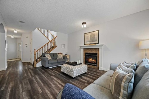 169 Panamount Green Nw, Calgary, AB - Indoor Photo Showing Living Room With Fireplace