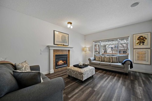 169 Panamount Green Nw, Calgary, AB - Indoor Photo Showing Living Room With Fireplace
