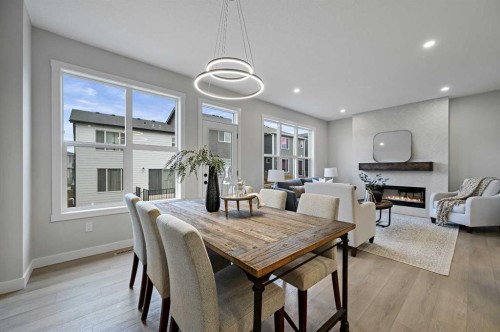 86 Versant Rise Sw, Calgary, AB - Indoor Photo Showing Dining Room With Fireplace