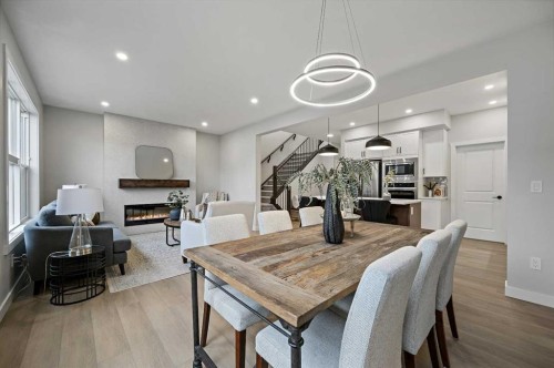 86 Versant Rise Sw, Calgary, AB - Indoor Photo Showing Dining Room With Fireplace