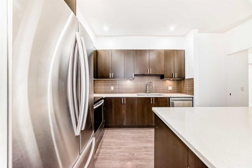 109-22 Auburn Bay Link Se, Calgary, AB - Indoor Photo Showing Kitchen With Stainless Steel Kitchen With Upgraded Kitchen