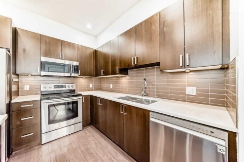 109-22 Auburn Bay Link Se, Calgary, AB - Indoor Photo Showing Kitchen With Stainless Steel Kitchen With Double Sink With Upgraded Kitchen