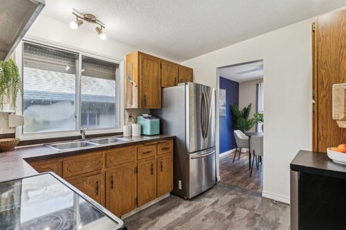 23 Dovercliffe Way Se, Calgary, AB - Indoor Photo Showing Kitchen With Double Sink