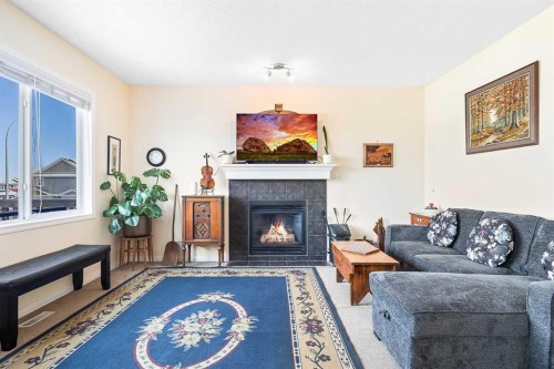 436 Cimarron Boulevard, Okotoks, AB - Indoor Photo Showing Living Room With Fireplace