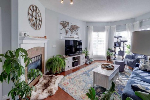 1310 23 Avenue, Didsbury, AB - Indoor Photo Showing Living Room With Fireplace