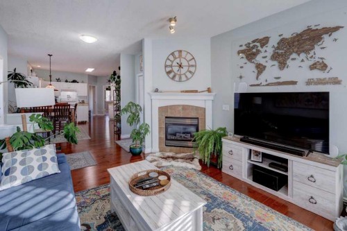 1310 23 Avenue, Didsbury, AB - Indoor Photo Showing Living Room With Fireplace