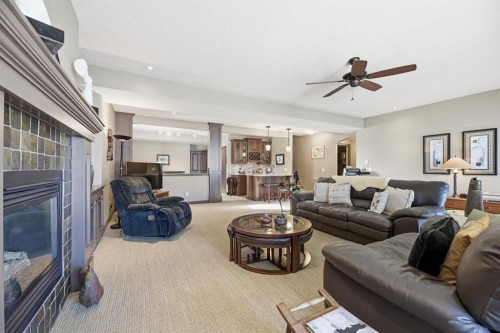 4 Bridle Estates Road Sw, Calgary, AB - Indoor Photo Showing Living Room With Fireplace
