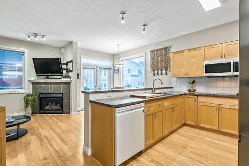48 Tucker Circle, Okotoks, AB - Indoor Photo Showing Kitchen With Fireplace