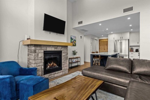 402-1315 Spring Creek Gate, Canmore, AB - Indoor Photo Showing Living Room With Fireplace
