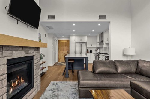 402-1315 Spring Creek Gate, Canmore, AB - Indoor Photo Showing Living Room With Fireplace