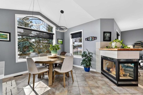 61 Somerset Crescent Sw, Calgary, AB - Indoor Photo Showing Dining Room With Fireplace