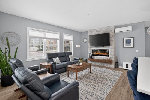 105-55 Wolf Hollow Crescent Se, Calgary, AB - Indoor Photo Showing Living Room With Fireplace