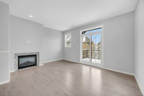 455 Ascot Circle Sw, Calgary, AB - Indoor Photo Showing Other Room With Fireplace