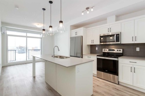 4111-200 Seton Circle Se, Calgary, AB - Indoor Photo Showing Kitchen With Stainless Steel Kitchen With Double Sink With Upgraded Kitchen
