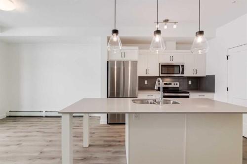 4111-200 Seton Circle Se, Calgary, AB - Indoor Photo Showing Kitchen With Stainless Steel Kitchen With Double Sink With Upgraded Kitchen