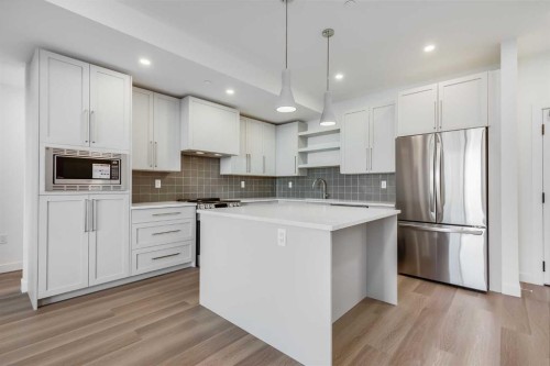 1308-520 Reynolds Avenue Sw, Airdrie, AB - Indoor Photo Showing Kitchen With Upgraded Kitchen