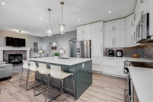 407 Morningside Crescent Sw, Airdrie, AB - Indoor Photo Showing Kitchen With Fireplace With Upgraded Kitchen