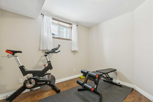 160 Sunset Close, Cochrane, AB - Indoor Photo Showing Gym Room