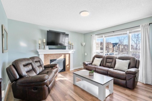 327 Copperstone Grove Se, Calgary, AB - Indoor Photo Showing Living Room With Fireplace