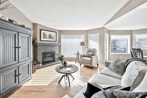 10 Bow Point, Cochrane, AB - Indoor Photo Showing Living Room With Fireplace