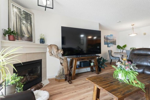 301-128 Centre Avenue, Cochrane, AB - Indoor Photo Showing Living Room With Fireplace