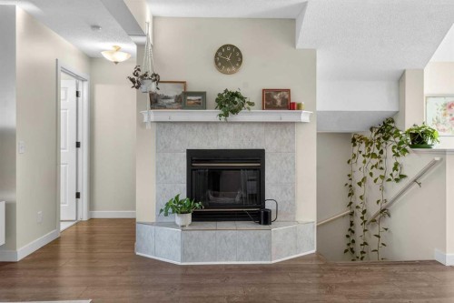 41 Sandarac Villas Nw, Calgary, AB - Indoor Photo Showing Living Room With Fireplace