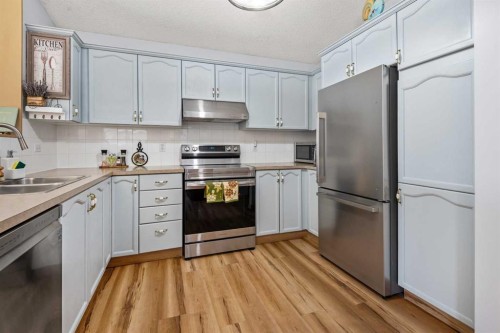 118 Bridleridge Way Sw, Calgary, AB - Indoor Photo Showing Kitchen With Double Sink