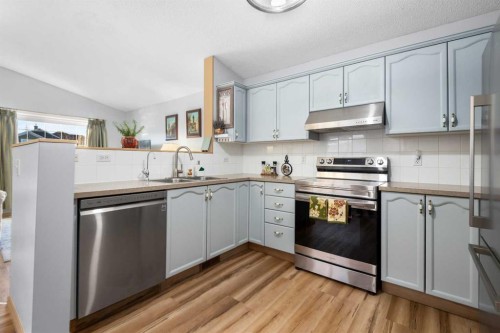 118 Bridleridge Way Sw, Calgary, AB - Indoor Photo Showing Kitchen With Double Sink