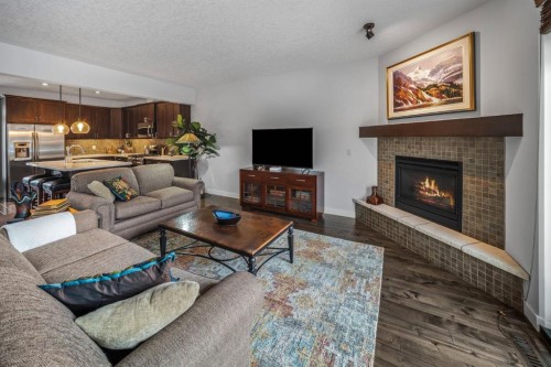 1-105 Rundle Drive, Canmore, AB - Indoor Photo Showing Living Room With Fireplace