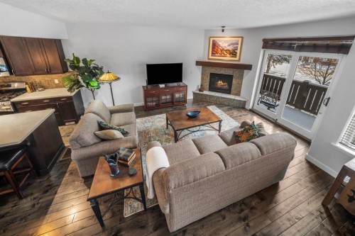 1-105 Rundle Drive, Canmore, AB - Indoor Photo Showing Living Room With Fireplace
