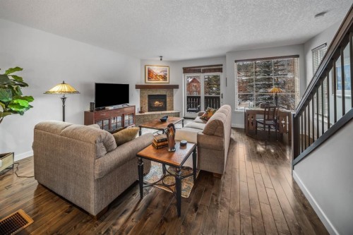 1-105 Rundle Drive, Canmore, AB - Indoor Photo Showing Living Room With Fireplace