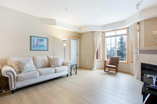 236-15 Everstone Drive Sw, Calgary, AB - Indoor Photo Showing Living Room With Fireplace