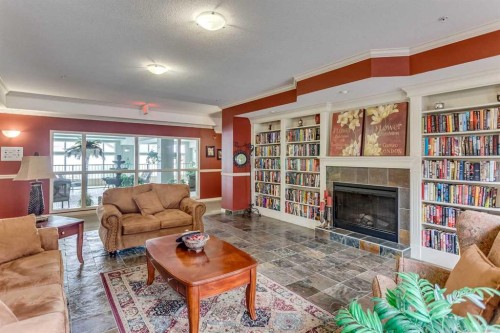 236-15 Everstone Drive Sw, Calgary, AB - Indoor Photo Showing Living Room With Fireplace