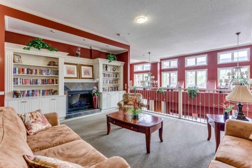 236-15 Everstone Drive Sw, Calgary, AB - Indoor Photo Showing Living Room With Fireplace