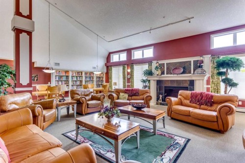 236-15 Everstone Drive Sw, Calgary, AB - Indoor Photo Showing Living Room With Fireplace