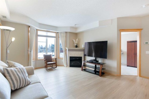 236-15 Everstone Drive Sw, Calgary, AB - Indoor Photo Showing Living Room With Fireplace