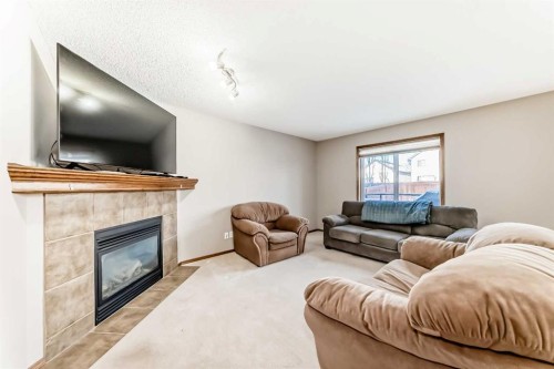 834 Cranston Drive Se, Calgary, AB - Indoor Photo Showing Living Room With Fireplace