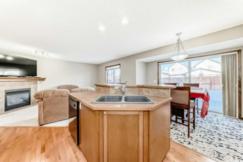 834 Cranston Drive Se, Calgary, AB - Indoor Photo Showing Kitchen With Fireplace With Double Sink
