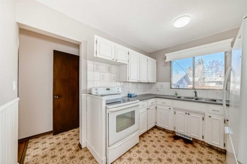 244 Huntridge Road Ne, Calgary, AB - Indoor Photo Showing Kitchen With Double Sink