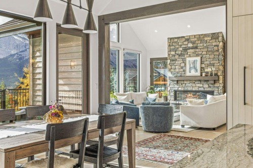 628 Silvertip Road, Canmore, AB - Indoor Photo Showing Dining Room With Fireplace