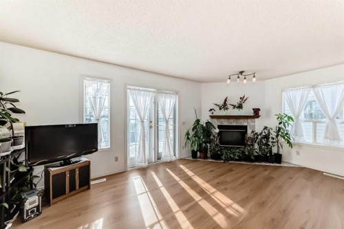 302 Applewood Drive Se, Calgary, AB - Indoor Photo Showing Living Room With Fireplace
