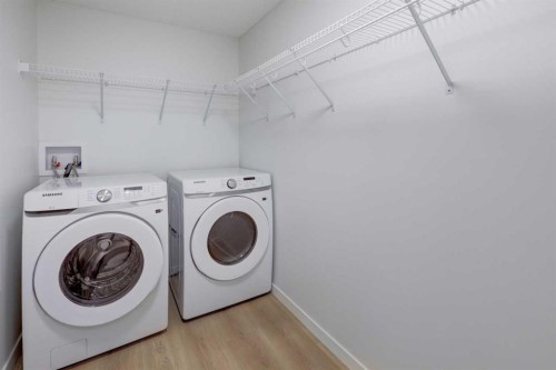 118-245 Edith Place Nw, Calgary, AB - Indoor Photo Showing Laundry Room