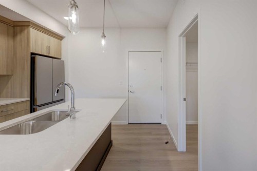 119-245 Edith Place Nw, Calgary, AB - Indoor Photo Showing Kitchen With Double Sink