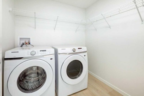124-245 Edith Place Nw, Calgary, AB - Indoor Photo Showing Laundry Room