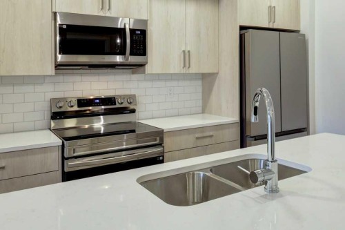 308-245 Edith Place Nw, Calgary, AB - Indoor Photo Showing Kitchen With Double Sink With Upgraded Kitchen