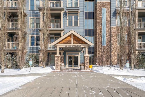 320-201 Sunset Drive, Cochrane, AB - Outdoor With Balcony With Facade