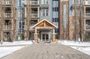 320-201 Sunset Drive, Cochrane, AB  - Outdoor With Balcony With Facade 
