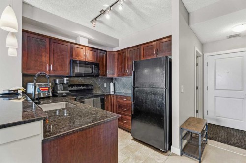 320-201 Sunset Drive, Cochrane, AB - Indoor Photo Showing Kitchen With Double Sink