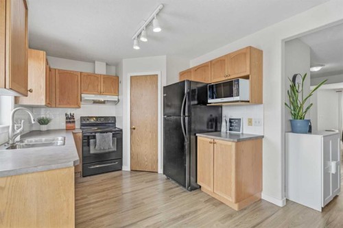 1301 Eagleview Place Nw, High River, AB - Indoor Photo Showing Kitchen With Double Sink